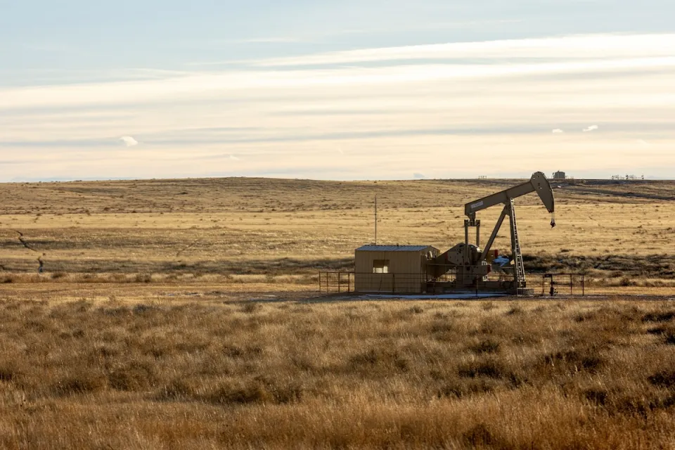 Oil well in prairie landscape.
